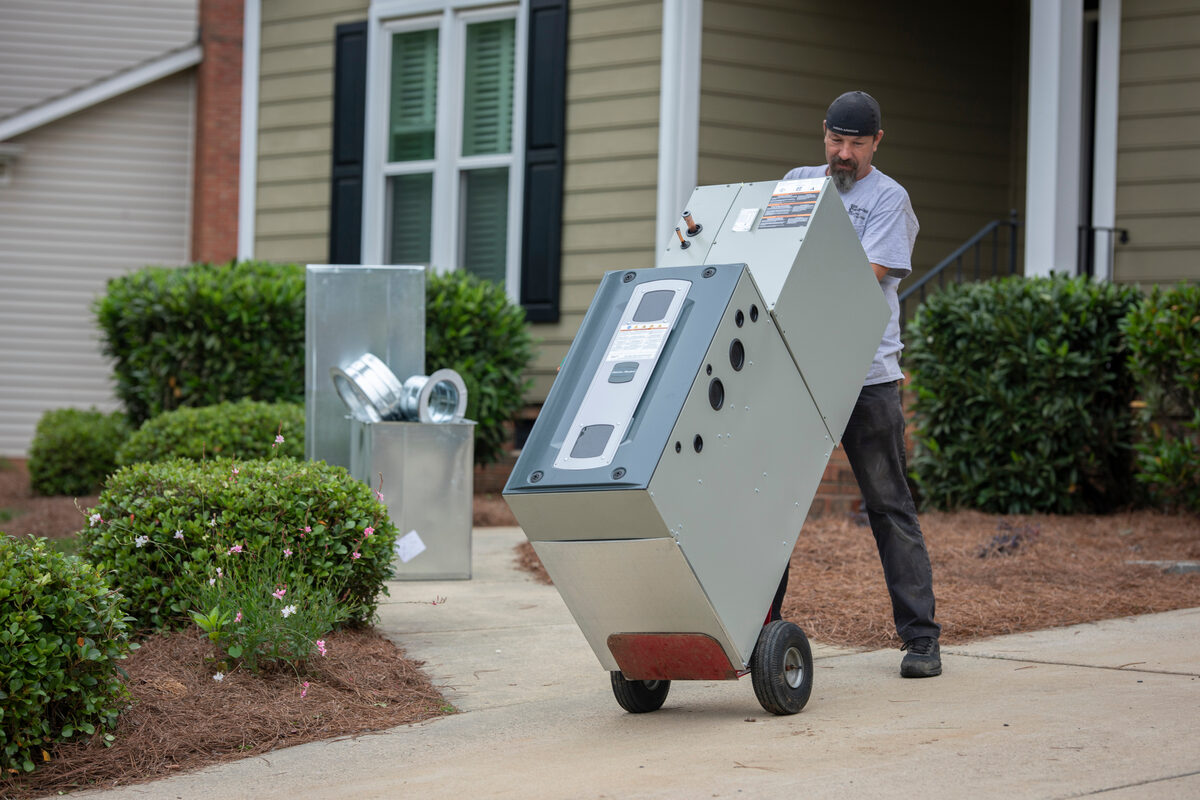 furnace being rolled up the driveway